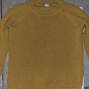 A mustard yellow sweater